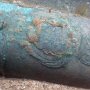 Close up of a crest on one of the cannon located on the wreck of the first-rate warship HMS Victory.